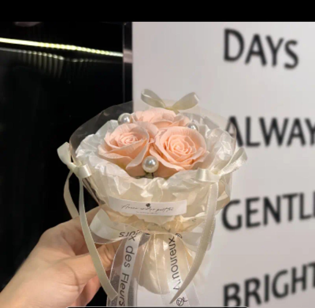 A bouquet of 3 flowers. A flower bag. A greeting card.