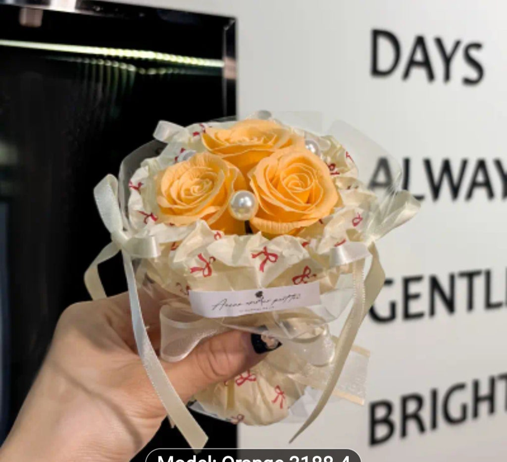 A bouquet of 3 flowers. A flower bag. A greeting card.
